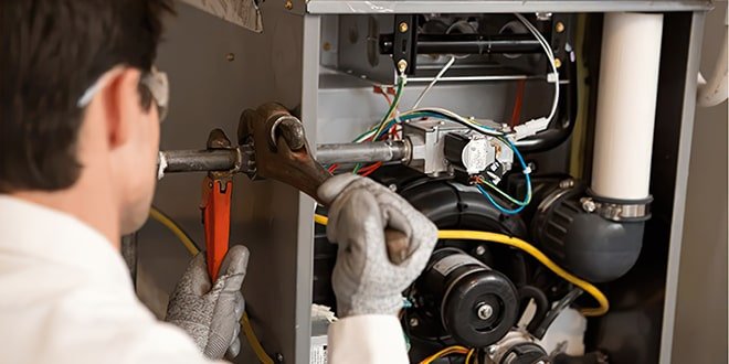 Furnace repair technician fixing a heating unit in Totowa, NJ